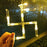 Detailed view of string lights with hanging props for festive decor.
