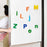 Colorful magnetic letters on a whiteboard